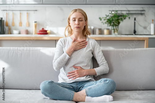 Woman doing calming breathing exercises after panic attack