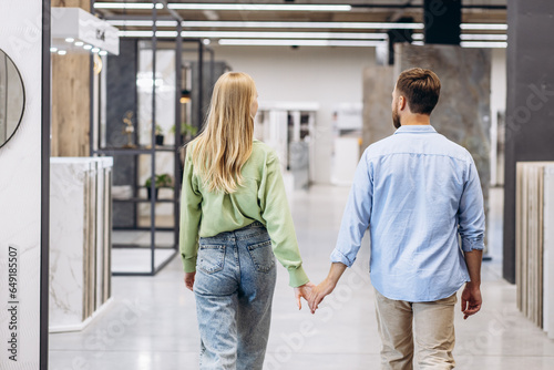 Young couple at the building market choosing tile