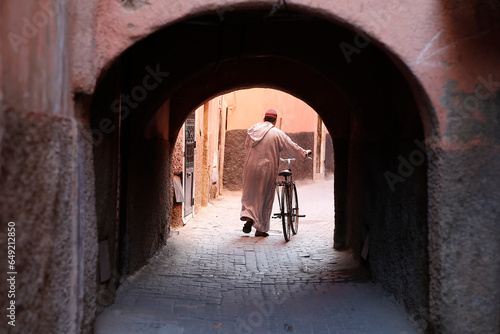 Man with bike in Marrakesh medina (old city), Morocco.