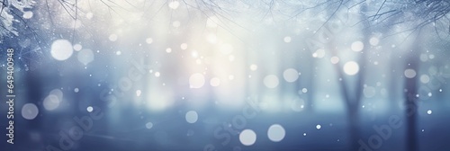 Blurred out winter season abstract nature background with lots of snowy bokeh and a bright center spotlight and a subtle vignette border.
