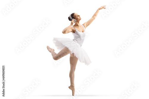 Full length profile shot of a ballerina dancing with headphones