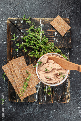 Fresh homemade chicken liver pate on a wooden board. vertical image. top view. place for text