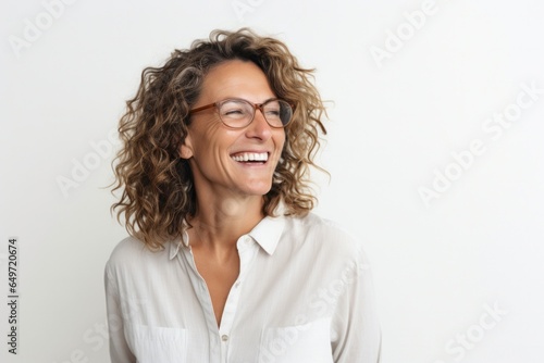 Portrait of a Israeli woman in her 40s wearing a chic cardigan against a white background
