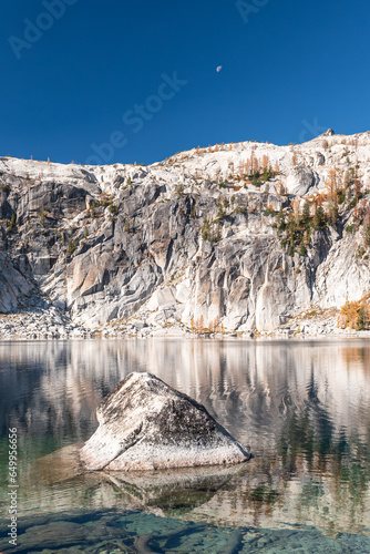 Granite cliffs and moon above Lake Viviane in Enchantment Lakes Wilderness in Washington