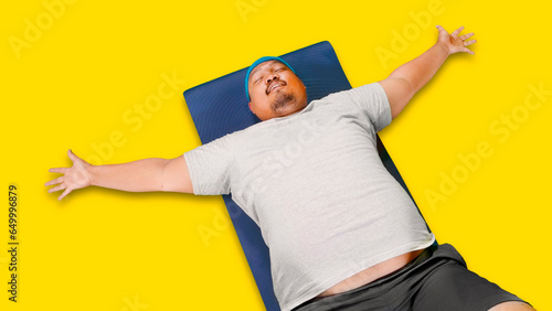 Top down view of obesity man wearing sportswear while doing sit ups on isolated over white background