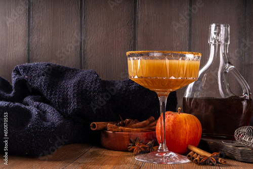Maple syrup autumn cocktails. Boozy strong alcohol, non-alcoholic mocktail drinks with apple cider, liqueur and spices, on dark wooden background copy space