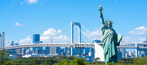 Tokyo, Japan. Odaiba, a popular tourist destination. A replica of the Statue of Liberty and the cityscape of Tokyo.