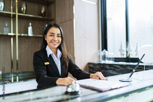 Beautiful asian hotel receptionist in uniforms at desk in lobby Friendly and welcome staff in hotel reception counter.