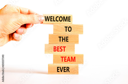 Welcome to best team symbol. Concept words Welcome to the best team ever on wooden block. Beautiful white table background. Businessman hand. Business motivational and welcome to best team concept