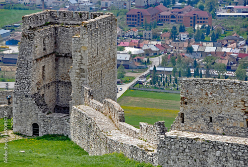 Fragment zabytkowych murów Zamku Spiskiego z widocznymi w tle zabudowaniami wsi Spiskie Podgrodzie. Spisske podhradie, Spissky hrad, Słowacja. 