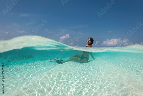 beautiful young woman enjoys snorkeling in the indian ocean. active holiday in the Maldives.