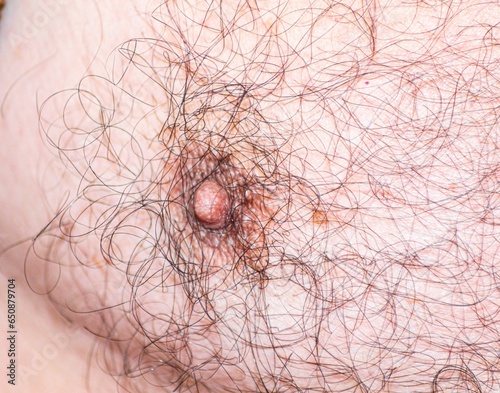 Close-up shot of a man's bare chest and nipple