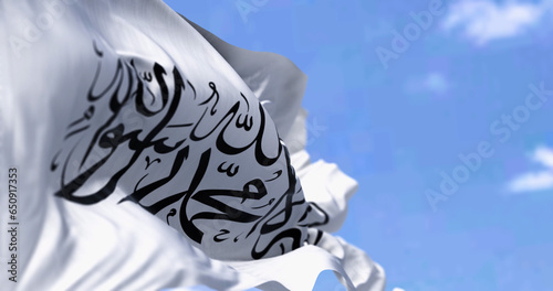 Flag of Islamic Emirate of Afghanistan waving in the wind on a clear day