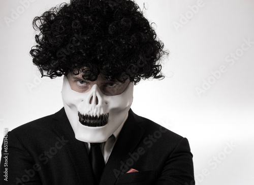 brutal killer in a mask on a dark background in the studio