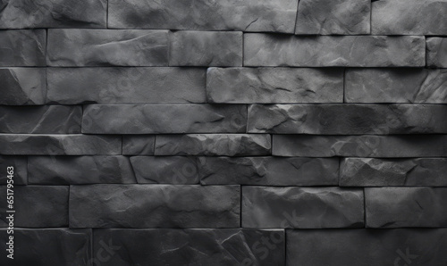 Close-up of a black stone block wall texture.