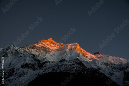 mountain peak in the snow at Sunset light