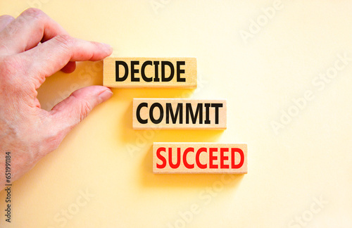 Decide commit succeed symbol. Concept word Decide Commit Succeed on beautiful wooden block. Businessman hand. Beautiful white table background. Business decide commit succeed concept. Copy space.