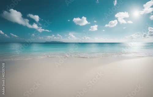 Beautiful beach with white sand, turquoise ocean water, and a blue sky with clouds on a sunny day