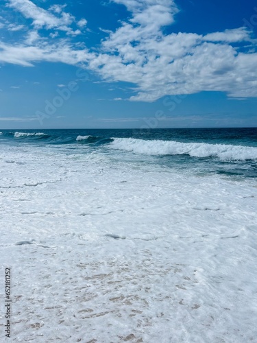 Waved seashore, sea water foam, powerful and fresh seascape, blue horizon