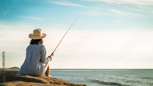 Serene angler woman lost in introspection while fishing at sea, a portrayal of calm, skill, and solitude against a soft horizon backdrop.