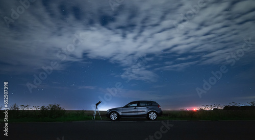 Telescope with car at night 