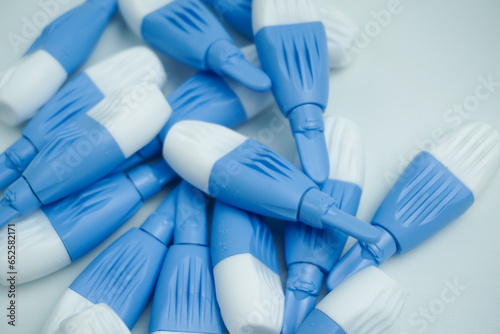 pile of blue lancets isolated on white background