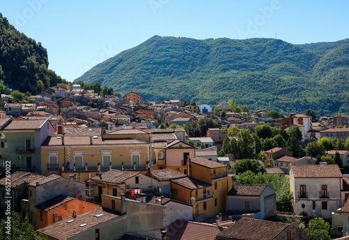 High angle of the beautiful buildings and forested hills of Lauria on a bright summer day in Italy