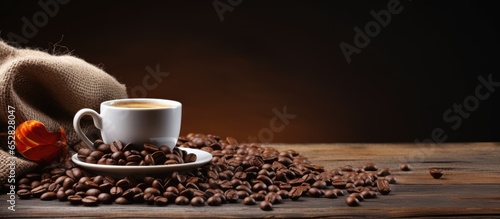 Vintage color tone coffee cup and beans on wooden table with sack background
