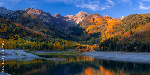 Scenic Silver lake reservoir landscape in Utah, Wasatch mountain range, under evening sunlight.