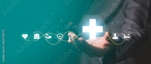 Businessman holds virtual medical network connection icon. The epidemic spreads and spreads interest in healthcare. Increased growth in the hospital and health insurance business
