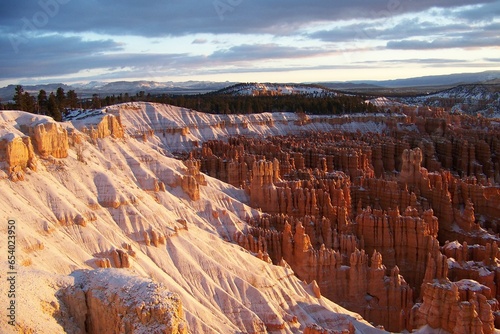 Slopes of Bryce Canyon early in the morning after a snowstorm. Winter sunrise at Bryce Canyon National Park, Utah, USA