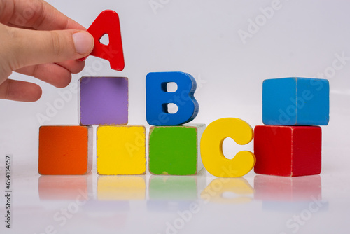 Hand playing with Colorful alphabet letters and building bloks