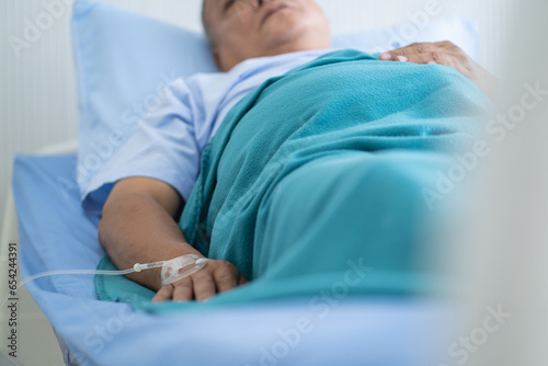 Patient lying on the bed and resting in hospital.