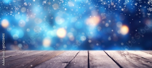 Beautiful winter snowy blurred defocused blue background and empty wooden floor.