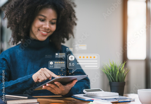 Close up of african american customer writing reviews, hand pressing on a smartphone screen with a golden five star rating feedback icon. Concept of rating and feedback for evaluation. Selective focus