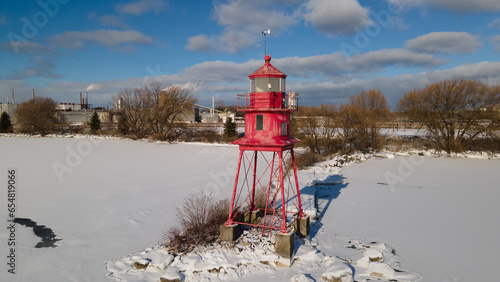 Alpena, Michigan historic lighthouse along Lake Huron in the winter.