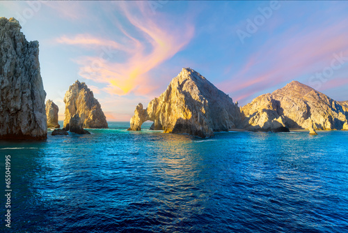 The El Arco Arch bathed in colorful light at sunset at the Land's End rock formations on the Baja Peninsula, at Cabo San Lucas, Mexico.