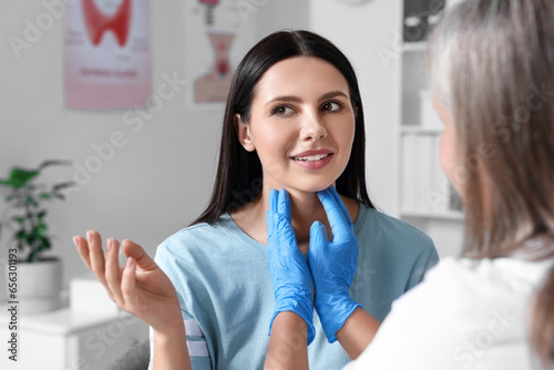 Endocrinologist examining thyroid gland of patient at hospital