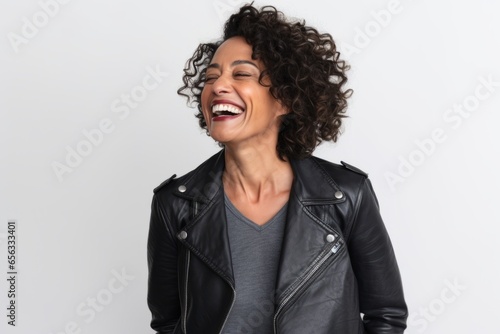 Portrait of a laughing african american woman in leather jacket