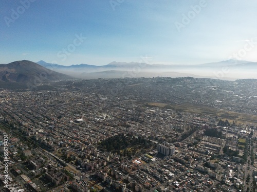 Aerial shot of Quito early in the morning, where you can see lots of volcanos. 