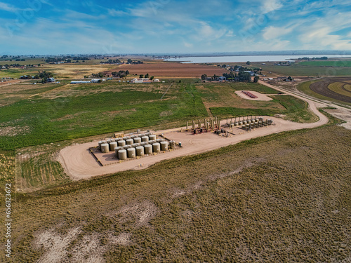 Oil frack pad in America's heartland. Next to farm fields, Drone aerial.