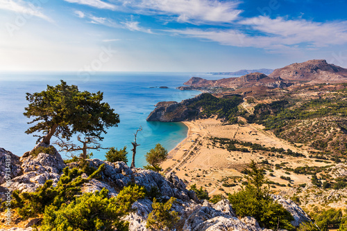 Tsampika beach with golden sand view from above, Rhodes, Greece. Aerial birds eye view of famous beach of Tsampika, Rhodes island, Dodecanese, Greece