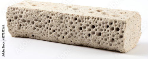 Texture of a pumice stone with a porous surface, covered in tiny pores that give it a spongy feel. Its light weight and ability to float on water make it ideal for use in baths and showers.