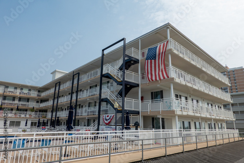 A restored motel with pool area and American Flag on the boardwalk