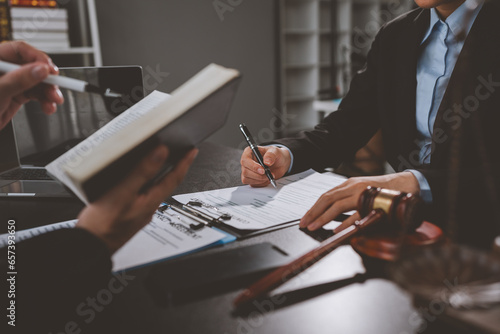 Consulting of business woman and male lawyer or legal consultant having team meeting with client, law, justice, law book, good service cooperation concept.