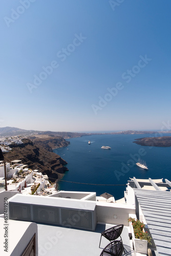 Apartment balcony in a white luxurious resort with great views of the Santorini Island shore Mediterranean Sea