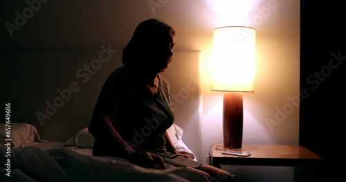 Troubled senior unable to sleep. Anxious older woman awake in the middle of the night suffering