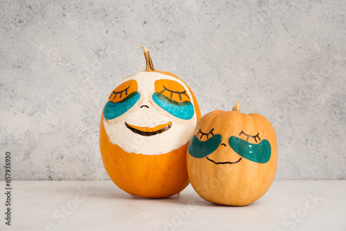 Pumpkins with under-eye patches and mask on light table