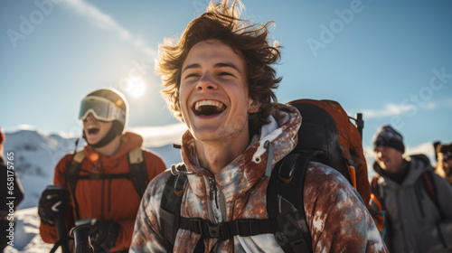 Portrait of a young man and his friends walking up a ski slope laughing and enjoying the moment