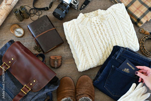 Travel flat lay - Laying out clothes and accessories for packing for cold weather travel trip